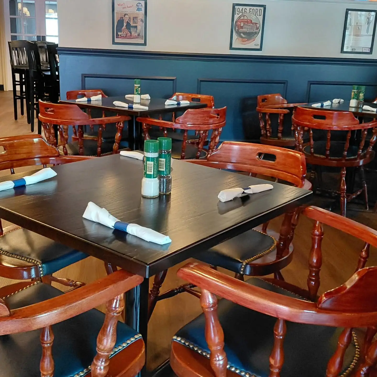 Dark wood tables with red Windsor chairs in the Bogey’s Tavern dining room