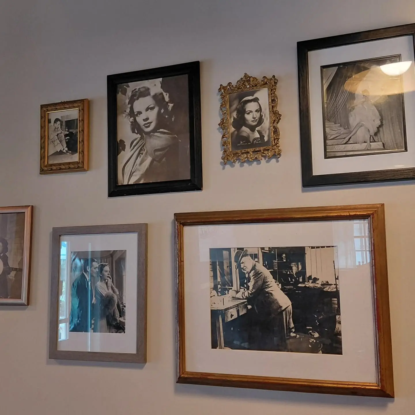 A wall of framed black-and-white photos of Hollywood stars