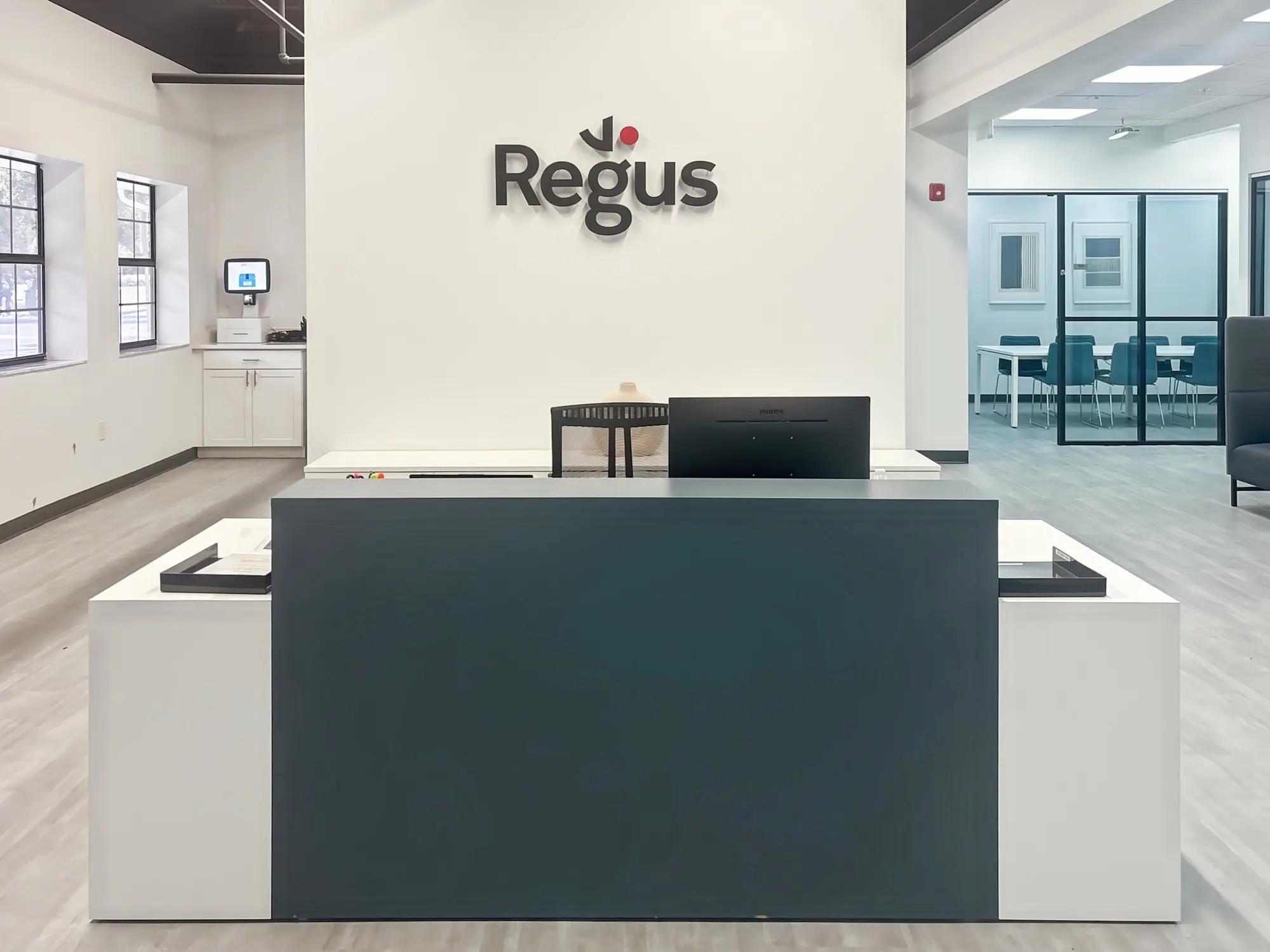 The Regus reception desk, with glass-walled meeting rooms behind it