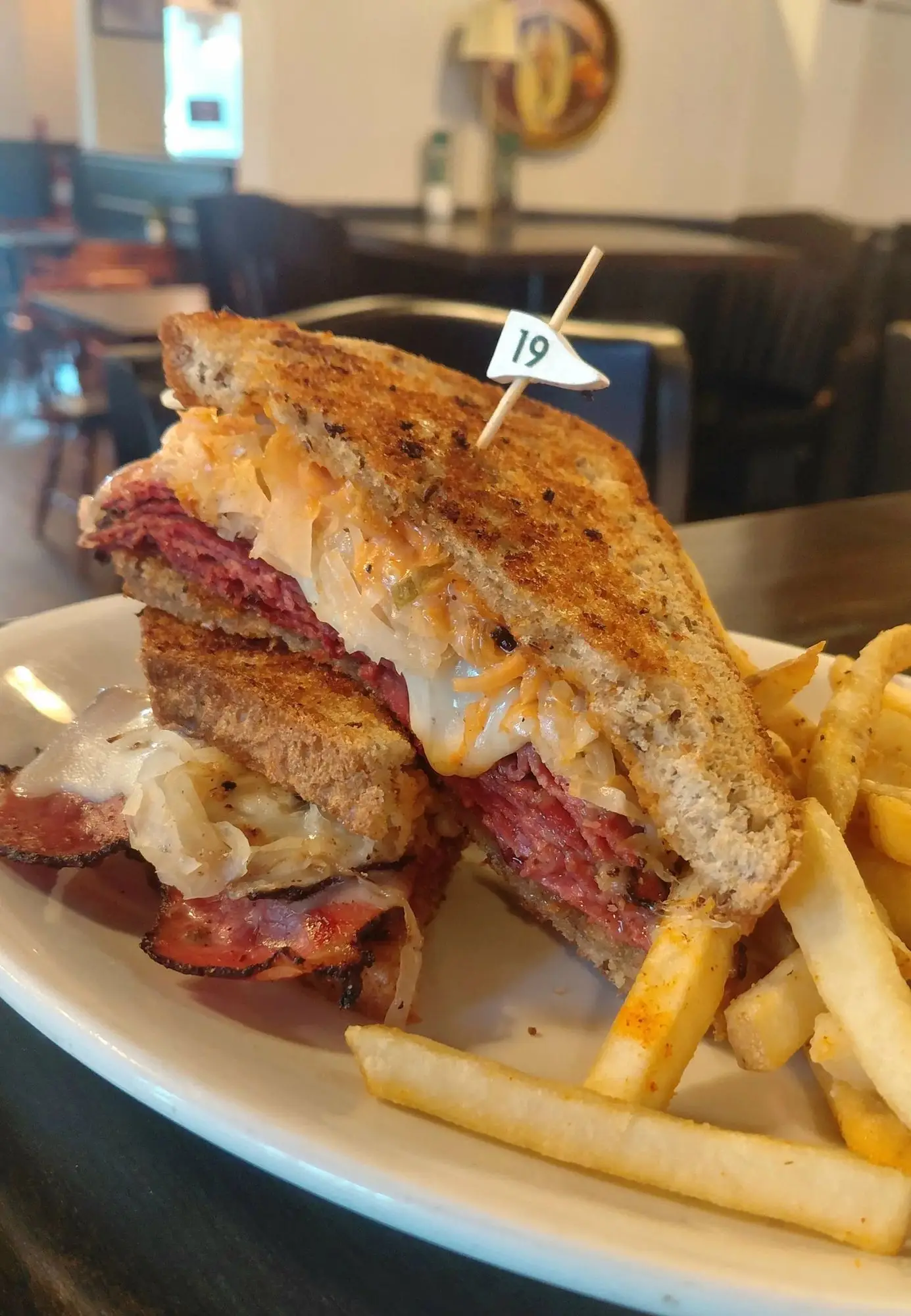 A grilled pastrami Reuben with fries at Bogey’s Tavern