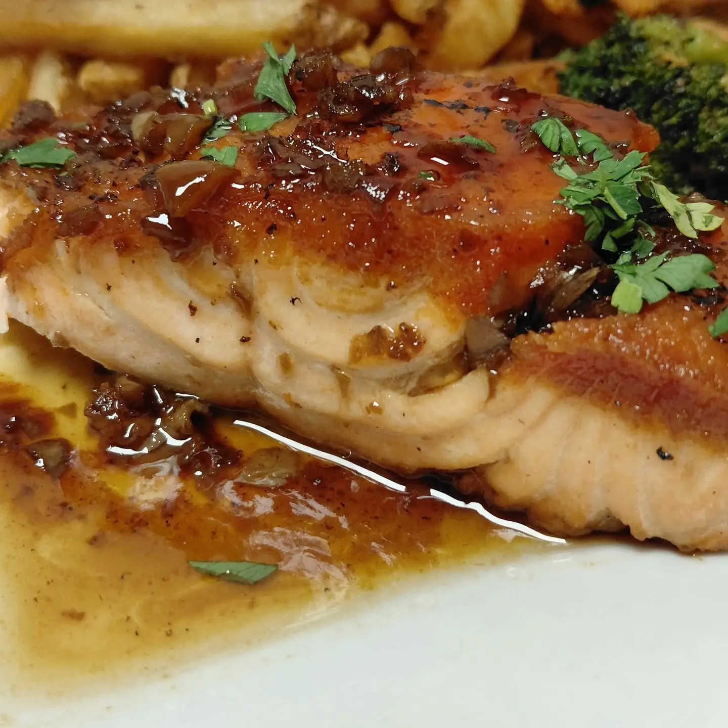 A glazed salmon fillet with fresh herbs