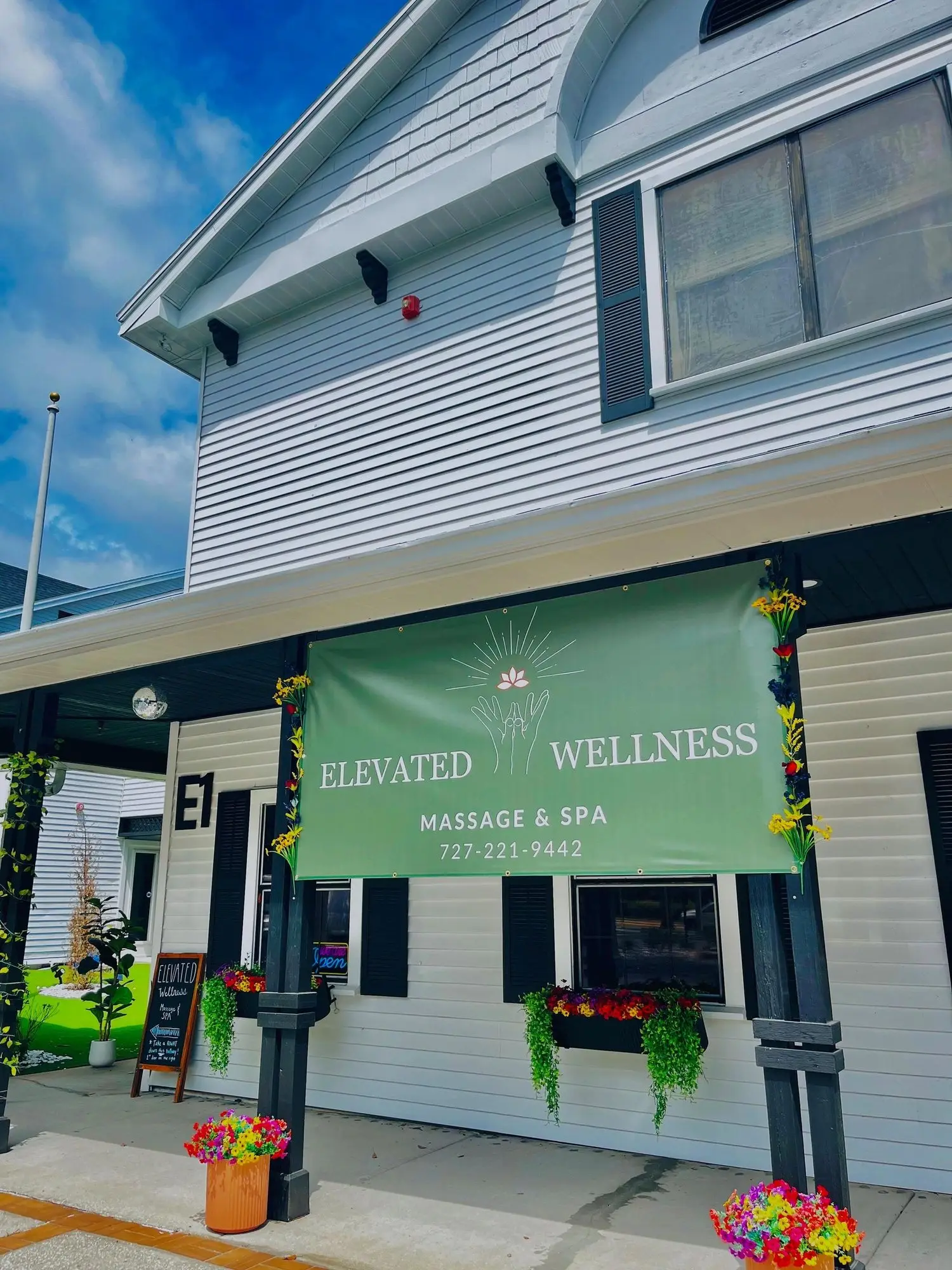 The Elevated Wellness banner on the front of the East building at MJ Village